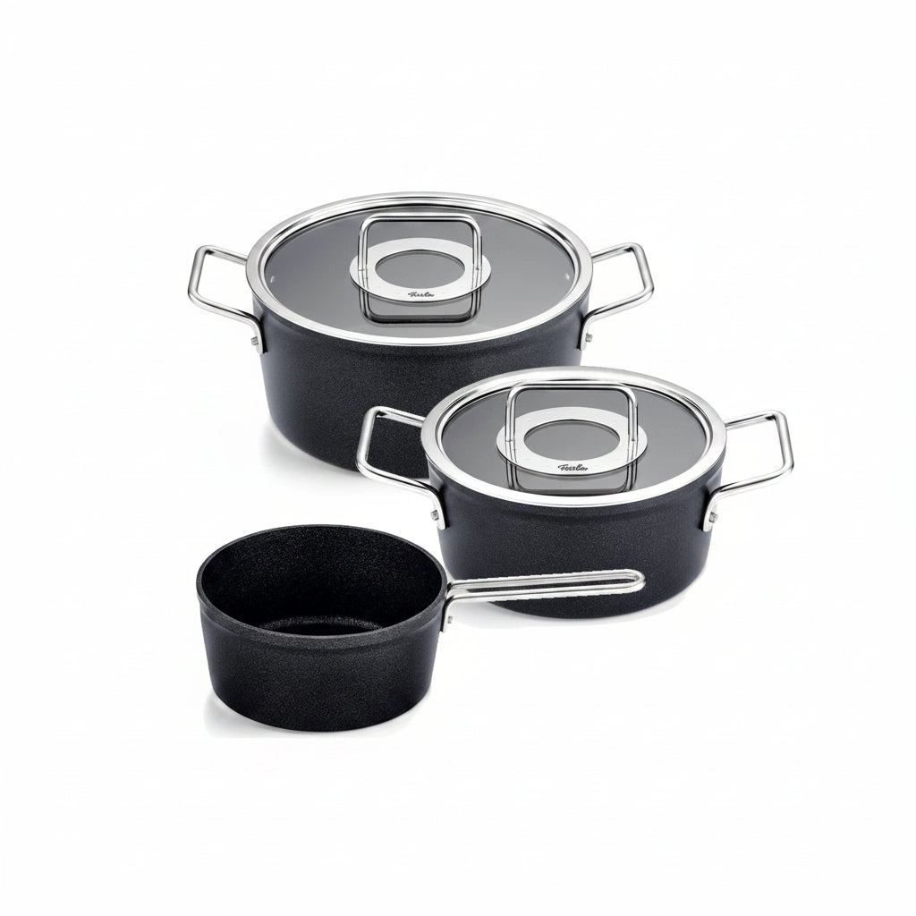 Set of black cookware with lids on a white background