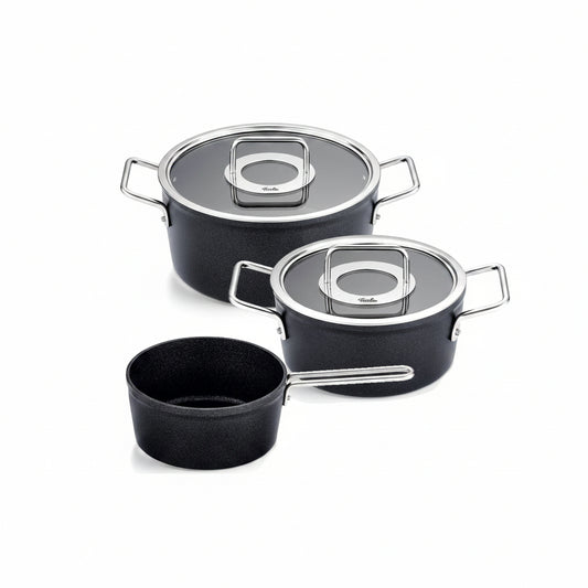 Set of black cookware with lids on a white background