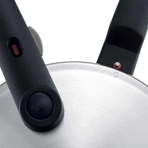 Close-up of a pressure cooker lid with black handles on a white background